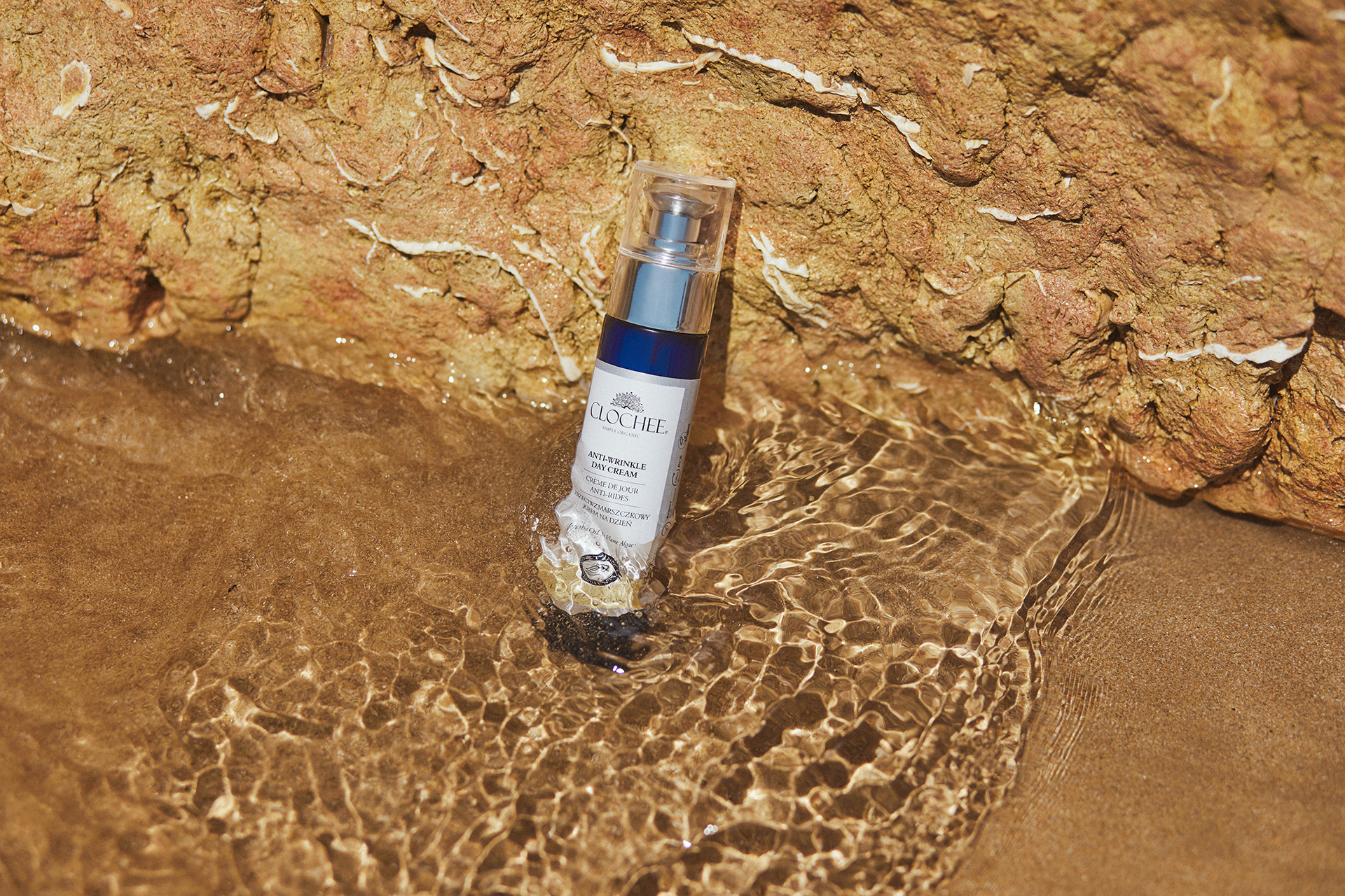 Produkt Clochcee Cosmetics oparty o kamienie, zanużony w wodzie